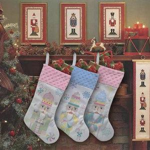 Three colorful Christmas stockings with nutcracker patterns hanging on a decorated fireplace
