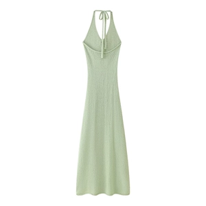 Detail view of backless knit dress with halter neck design and fine ribbed texture in green