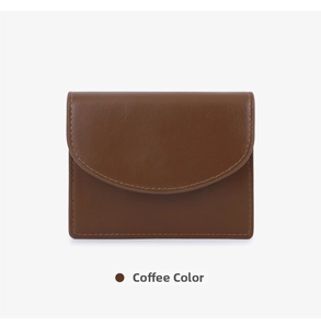 Detail view of coffee brown leather card holder featuring curved flap and fine stitching