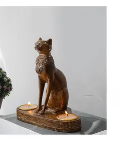 Detail of bronze Egyptian Bastet cat candle holder with carved hieroglyphic patterns