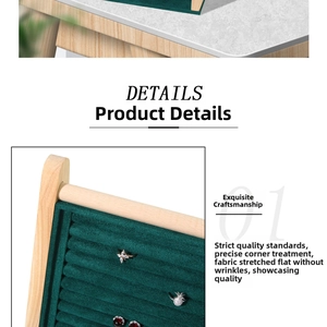 Detail view of wooden jewelry display rack with dark green velvet slots for rings