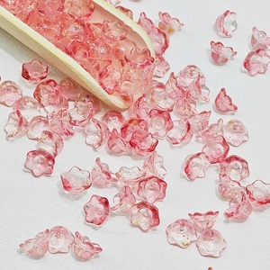 Macro detail of pink lily of the valley glass beads with gold foil for DIY jewelry making