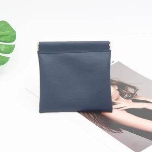 Detail showing squeeze metal closure on navy blue PU leather pouch for small accessories