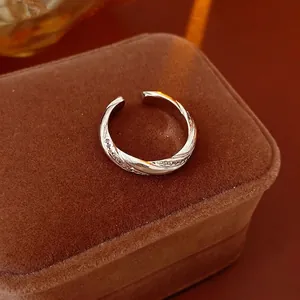 Silver twisted open ring with pavé-set zircon crystals on brown velvet jewelry box