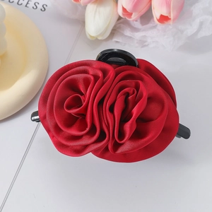 Elegant wine red satin rose hair claw clip for women on an aesthetic floral background