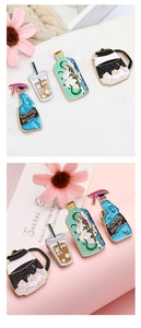 Detailed set of four enamel pins including a glittery spray bottle and a ship in a bottle