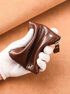 Slim retro brown leather coin purse with zipper closure and rivet details