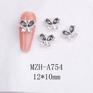 Macro shot of 12x10mm 3D butterfly nail charms with silver metal edges and grey rhinestones