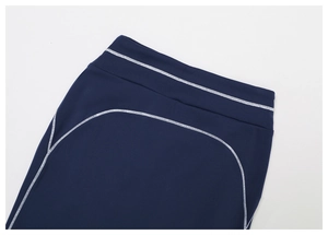Detail of high-stretch dark blue leggings with white flatlock stitching and wide waistband