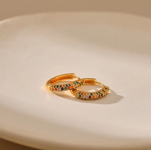 Close-up of 18K gold plated hoop earrings with micro-paved rainbow cubic zirconia crystals