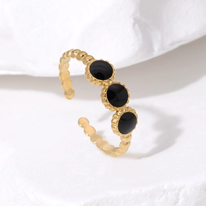 Detail of gold open ring featuring three black enamel beads and vintage beaded textures