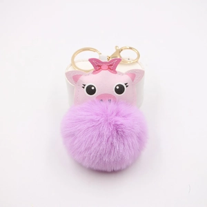 Detailed view of pink pig plush ball keychain with purple fur and golden metal ring hook
