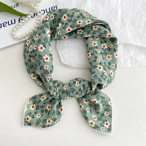 Green floral cotton linen scarf used as a headband or neck scarf on a white background