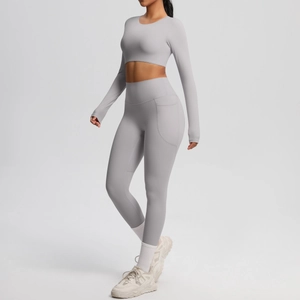 Detail of high-waist yoga leggings with side pockets in brushed light gray fabric