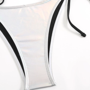 Close-up of silver laser bikini bottoms with black trim and premium stitching details