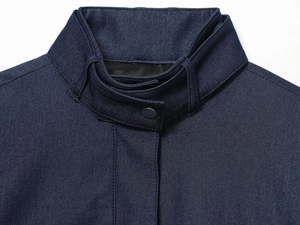 Close-up of navy blue bomber jacket showing stand collar and twill fabric texture