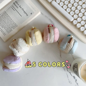 Detailed view of five colorful quilted mini earphone cases with elegant pearl zippers