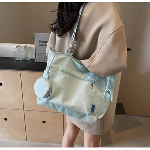 Detail of light green Oxford tote bag with matching coin purse and wide shoulder strap