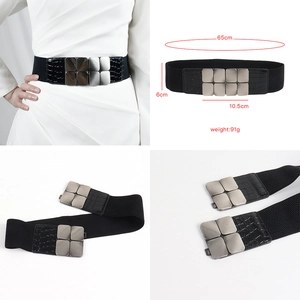 Detailed black elastic waist belt with silver geometric buckle and crocodile texture