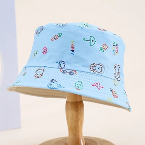 Close-up of children's blue bucket hat with colorful animal prints on a wooden stand