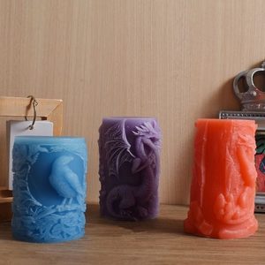 Detailed view of colorful embossed pillar candles featuring dragon and bird textures