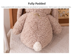 Close-up of brown plush bunny tail with soft curly faux fur texture and gold neck cord