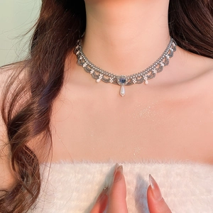 Detail of beaded lace choker with blue crystal and white teardrop pearl pendant