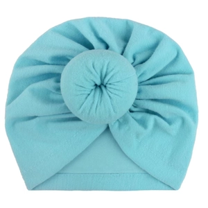 Close-up of baby turban hat featuring a decorative donut knot in soft light blue fabric