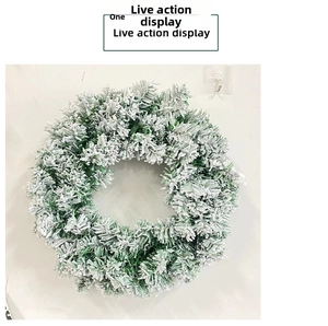Detail of Christmas wreath with realistic pine needles and thick white artificial snow