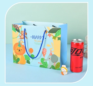 Detailed view of light blue animal gift bag with lion and elephant illustrations