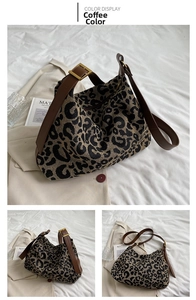 Close-up of leopard print tote bag with brown leather straps and gold metal buckle detail