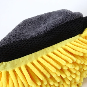 Close-up of yellow chenille microfibers and grey breathable mesh on a car wash mitt