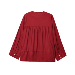 Detailed back view of dark red linen jacket featuring pleated waist and natural fabric texture