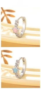 Macro detail of star hoop earrings with pink and blue enamel and zircon inlay