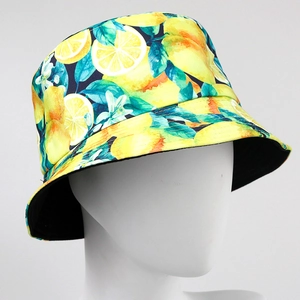 Reversible bucket hat featuring vibrant yellow lemon prints on a navy blue background