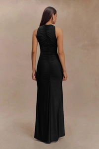 Detailed back view of sleeveless black maxi dress with elegant ruched spine design