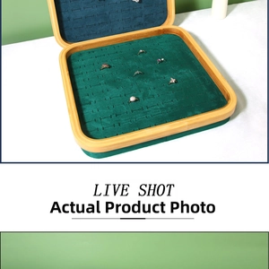 Detailed view of bamboo jewelry tray with green velvet lining and multiple ring slots