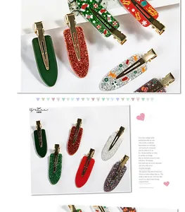Detail of Christmas claw clips with gingerbread man and candy cane festive patterns