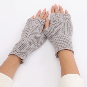 Detail of grey knitted fingerless gloves showing intricate hollow fish scale pattern textures