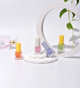 Water-based peel-off nail polish bottles in orange, pink glitter, purple, and green shades