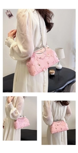 Detail of pink floral embroidery and vintage metal clasp on a stylish chain crossbody bag