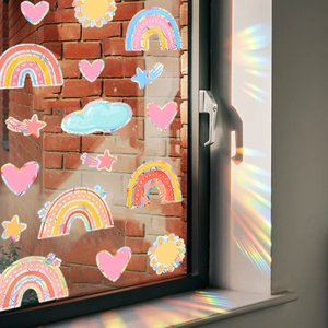 Rainbow window decals with cloud and heart shapes creating colorful suncatcher light effects