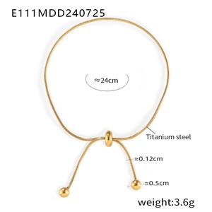 Detail of adjustable 18K gold plated titanium steel slider clasp with ball tassels