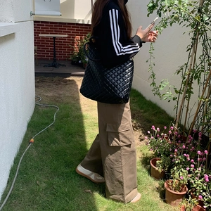 Large black quilted tote bag with diamond pattern for women's stylish daily commuting