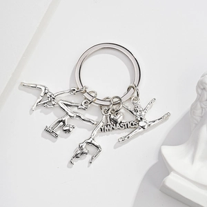 Detail of silver gymnastics keychain with I LOVE GYMNASTICS tag and athlete charms