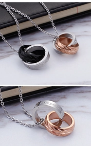 Detail of interlocking couple necklaces featuring engraved Love you till the end text