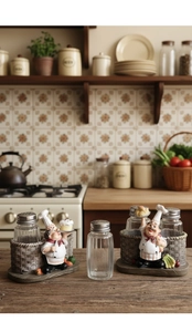 Detail of chef resin base with glass pepper shakers on a rustic wooden countertop