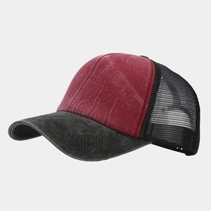 Detail view of burgundy washed cotton trucker hat with breathable black nylon mesh
