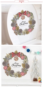 Detail showing vintage hand-painted Christmas wreath decal with red bow on white surface