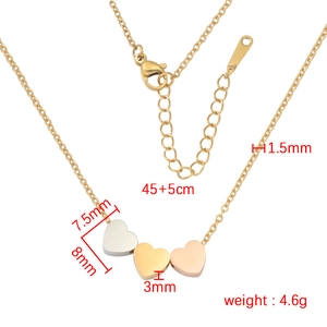 Three-tone heart pendant necklace in gold, silver and rose gold finishes on white background